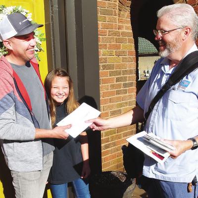 CDN I Robert S. Bryan Mail carrier Jimmy Ferrero delivers a U.S. Census form to Clinton resident Randy Jones and his daughter, fifth-grader Esme Jones.