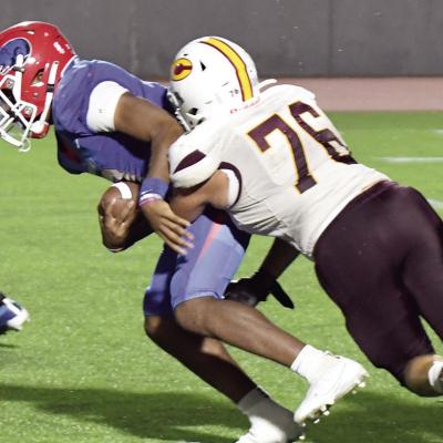Jordan Brown tackles John Marshall’s Davien Taylor in the backfield for a loss. CDN | John Kinsey Clinton, Elk City square off Friday
