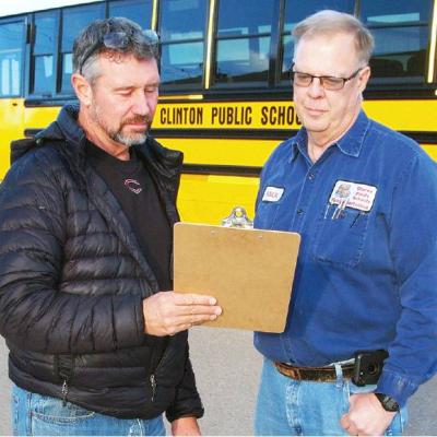 CPS Transportation Director Kelly Gaunt, left, and transportation department mechanic Rick Challis. Clinton buses traveled 232,689 miles last year