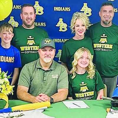 Jaycee South is all smiles as she celebrates signing to play softball at Western Oklahoma State University in Altus with her family. Pictured, in front, from left are WOSC’s head softball coach Jerod Stidham and South; back, her brother Jaxton South, fa Two Lady Indians sign to play college softball