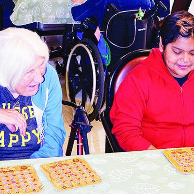 Clinton Middle School seventh-grader King Maddox, right, speaks with Teresa Griffin at River Valley Skilled Nursing and Therapy during a game of bingo last week. CDN | Michael Maresh