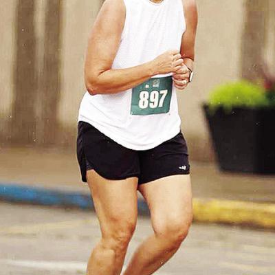 Newly-minted Clinton cross country coach Ashley Griffith runs down Frisco Avenue during the Clinton Classic Run this year. CDN | Courtesy photo