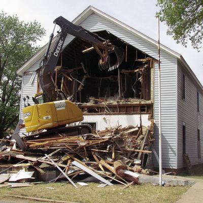 The Mission House living quarters gets torn into by an excavator around noon Tuesday. The Mission House’s kitchen will be closed until further notice during the demolition process. CDN | Christian Jacobsen