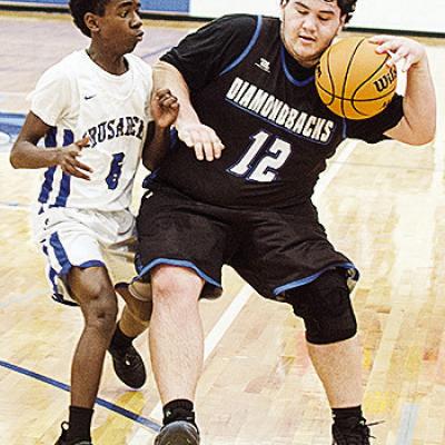 CBA’s Rolando Beadle guards the Olustee-Eldorado player as he tries to dribble the ball up the court in the Crusaders’ home win Thursday over the Diamondbacks. CDN | Sam Goodwyn