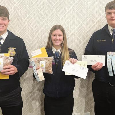 Arapaho-Butler FFA students who participated in the 2021 State Wheat Show showing off their winning wheat samples from left are Blake Hunter, Brecken Hunter and Charley Baker. A-B FFA chapter engaged in busy season