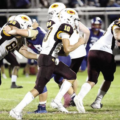 Clinton’s No. 10 JJ Ruiz carries the ball against Chandler Friday while No. 66 Andre Lime and No. 75 Eli Anderson provide blocks for him during the road game. CDN | John Kinsey Clinton’s No. 10 JJ Ruiz carries the ball against Chandler Friday while No. 66 Andre Lime and No. 75 Eli Anderson provide blocks for him during the road game. CDN | John Kinsey