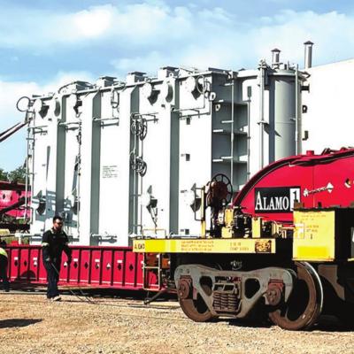 A wind turbine transformer can be seen being loaded onto a transport truck from the railway platform Friday afternoon before it was sent to the new wind turbine farm southeast of Custer City. This is the second of three expected shipments. Huge transformers headed to area wind farms