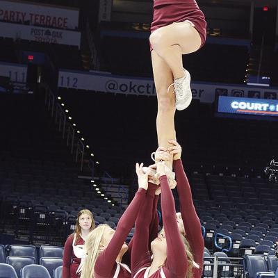 Clinton cheerleaders pump up the crowd during the “Court of Dreams” game at the Paycom Center in Oklahoma City as Jaycee Rodebush, left, Presley Evans, back, and Mia Coxwell, center, hold up Addison Newcomb in a tower formation. CDN | Sam Goodwyn Clinton cheerleaders pump up the crowd during the “Court of Dreams” game at the Paycom Center in Oklahoma City as Jaycee Rodebush, left, Presley Evans, back, and Mia Coxwell, center, hold up Addison Newcomb in a tower formation. CDN | Sam Goodwyn