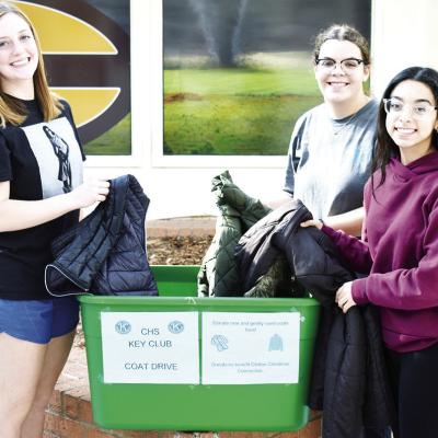 Key Club members from left Presley Evans, Rebekah Campbell and Juliette Gonzales help conduct the coat drive their club is putting on until Dec 1. CDN | Caleb Blanchard Key Club to gather up coats to help folks