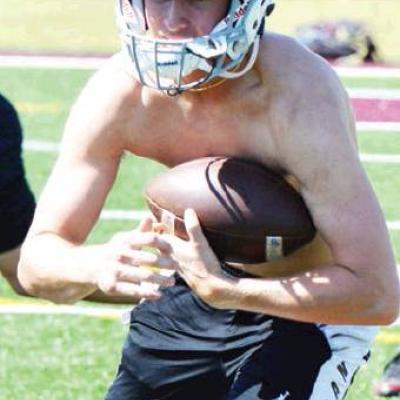 CDN | Collin Wieder Clinton utility offensive player Zade Cisneros runs with the football at spring practice. Article Image Alt Text