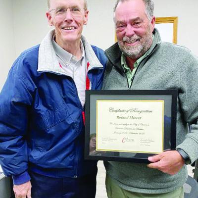 CEDA Chairman Ken Baker, left, presents recognition to Roland Mower, who attended his final meeting as director of economic development. CDN | Staff Photo