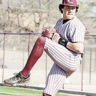 CDN | Sam Goodwyn Clinton’s Easten Powell kicks up his leg as he prepares to pitch against El Reno at home.