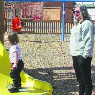 Brynlee Zapien, left, plays with her Grandma Deidre Scott on the slide at the M.T. and Helen Gholston Children’s Park.