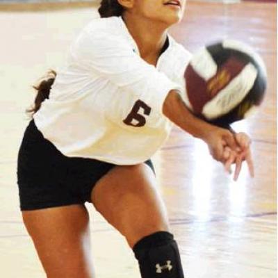 CDN | Collin Wieder Clinton freshman Clariza Ramos bumps the ball back over the net against CBA. Article Image Alt Text