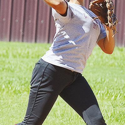 Senior Audrina Trout hurls the ball toward first during practice Tuesday at the softball fields. CDN | Sam Goodwyn