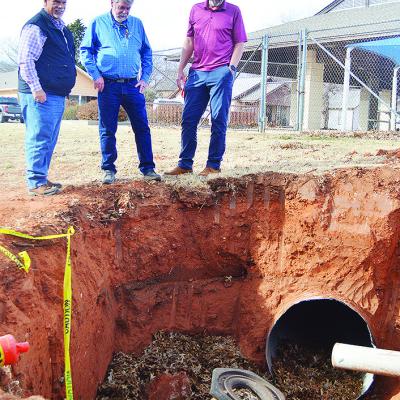 From left, Dist. 1 Commissioner Wade Anders, Gary Brickley, and Clinton Public Works Director Gene McCullough take note of the state of a damaged drainage pipe Monday afternoon in McLain Rogers Park, just outside of the Clinton Public Pool. CDN | Micah As