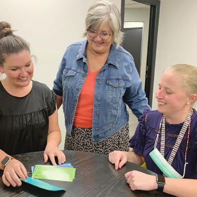 From left Melissa Stewart, Principal Janalyn Taylor and Hillary Barnes look over the new goal cards for their students at Nance Elementary. CDN | Emily Stephens Nance Elementary adding programs