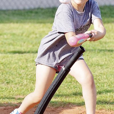 Valarie Tobias swings mightly at the ball during a Noon Lion’s Club T-Ball game at Schumacher Fields at Acme Brick Park. CDN | Sam Goodwyn