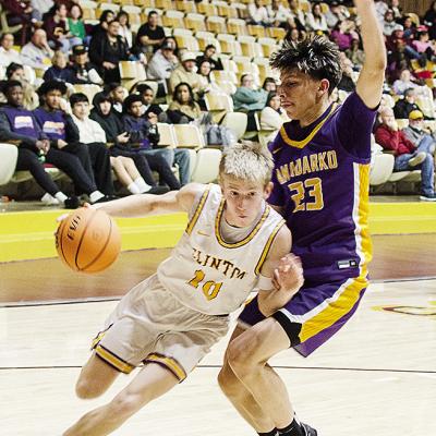 Clinton’s Ryder Adams, left, drives against the Anadarko defender during the Reds’ home game against the Warriors Tuesday in the Tornado Dome. CDN | Sam Goodwyn