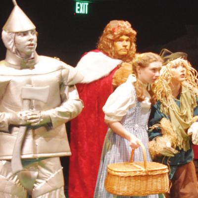 Trembling at meeting the Wizard of Oz during Southwest Playhouse’s production of “The Wizard of Oz, Young Performers Edition,” from left, are the Tin Man (Gavin Houck), the Lion (Nathan DeVaughan), Dorothy (Samantha Rother) and the Scarecrow (Hannah Cast flies over rainbow in ‘Wizard of Oz’