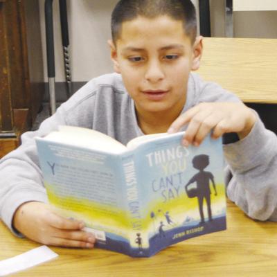 Fifth-grader Eduardo Martinez reads from the book “Things you can’t say” at Eastside Academy last week. CDN | Michael Maresh