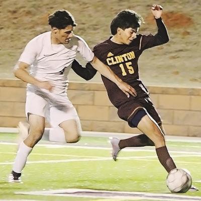 Clinton’s Anthony Velasquez, right, fights against an Elk City defender during the Reds home game against the Elks last year. CDN | Emily Stephens Senior enjoys working hard for titles