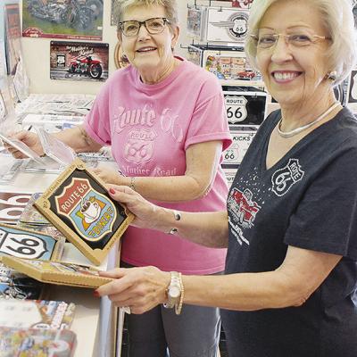 Volunteers Karen Traivs, left, and Melba Ballard work to stock the gift shop at the Oklahoma Route 66 Museum. CDN | Caleb Blanchard Museum is national favorite