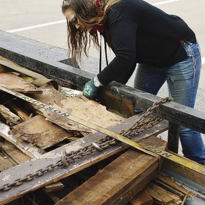 Kristy Van Allen ties down some of the debris removed from the City of Clinton’s demolition of the house at 1013 Avant Ave. CDN | Michael Maresh Kristy Van Allen ties down some of the debris removed from the City of Clinton’s demolition of the house at 1013 Avant Ave. CDN | Michael Maresh