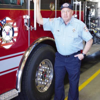 Clinton Firefighter John Denney stands next to a fire engine at the station. CDN | Michael Maresh Clinton Firefighter John Denney stands next to a fire engine at the station. CDN | Michael Maresh