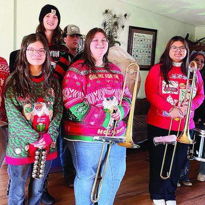 CHS band members playing songs included, from left, Charles Terrell, Jesus Bonilla, Hazel Hoffman, Jackson McCullough, Corbin Weaver, Abigail Williams, Belicia Gamon, Jules Harrison, Karely Aguilar Guzman, Ashley Garcia and homeowner Mike Mapel. Not pictu CHS band members playing songs included, from left, Charles Terrell, Jesus Bonilla, Hazel Hoffman, Jackson McCullough, Corbin Weaver, Abigail Williams, Belicia Gamon, Jules Harrison, Karely Aguilar Guzman, Ashley Garcia and homeowner Mike Mapel. Not pictu