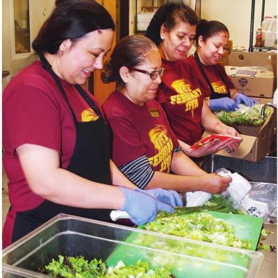 Southwest Elementary cafeteria workers, from left, Magnelia Andablo, Dolores Torres, Blanca Hernandez and Martha Lopez work at preparing lunch for the hungry students. CDN | Robert S. Bryan Article Image Alt Text