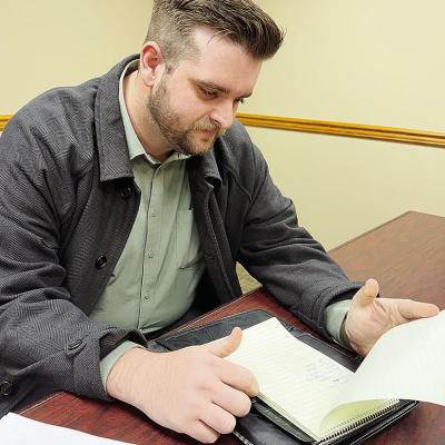 Detective Paul Sperle looks over notes for a case before starting his day at the Clinton Police Department. CDN | Shiann Dawson