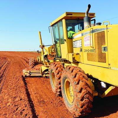 Rod Fauver uses a blade scraper to smooth out one of the tracks in the Clinton Speedbowl as he and his partner Joe McConnell set up the racetrack for future events. CDN | Courtesy photo