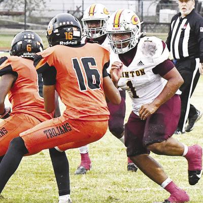 No. 1 Malachi Lorne prepares to block a couple of Douglass defenders to allow his teammate, Kyn’Tavion Hill, room to slip by in Clinton’s regular season-ending win last week over the Trojans in Oklahoma City. CDN |John Kinsey Clinton looks to upset reigning 4A state champs