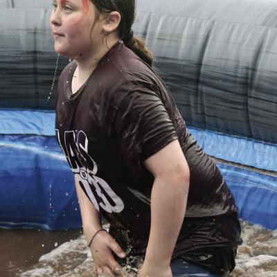 Sophia Guinn, a Washington sixth-grade student, has a splashing good time as she zipped down the water slide at McLain Roger’s Park during her school’s end-of-year party. CDN | Elisha Rangel Almost dry