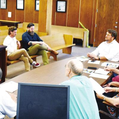Rick Koch, left, gives his presentation on plans to renovate the Glancy Motel and Pop Hicks properties Tuesday at City Hall to the Clinton Economic Development Authority. Seated to the right are Geoff Park and Mathew Blakeburn, who also presented their pl Koch’s proposal chosen by CEDA