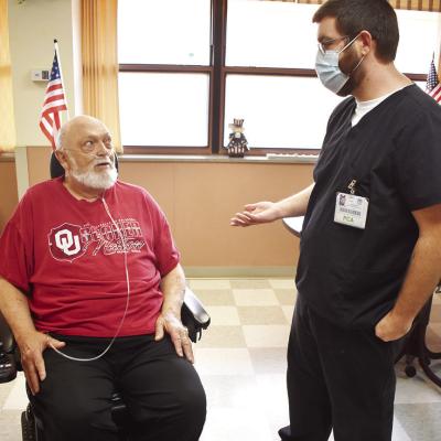 Clinton Veterans Center resident Michael Seward, left, and Kyle Keller spend time talking about upcoming activities. CDN | Emily Stephens Veterans Center celebrates state’s ranking for veterans