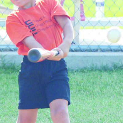 Ayden Taylor smacks the ball during one of his Noon Lions Club T-ball games at Schumacher Fields at Acme Park. CDN | Sam Goodwyn OB&T's Rising Stars