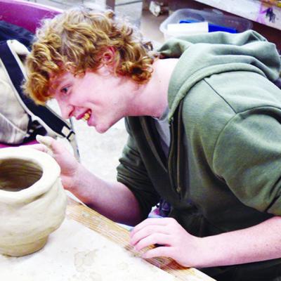 Junior Wylder Smith puts the finishing touches on his clay project in Clinton High School’s Art 3 class. CDN | Michael Maresh Junior Wylder Smith puts the finishing touches on his clay project in Clinton High School’s Art 3 class. CDN | Michael Maresh