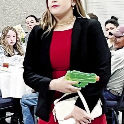 Mock trial member Kinsley Bridges, playing the role of Miss Scarlett in an adapted version of “Clue,” shows her “murder weapon” Monday night at the Frisco Center. CDN | Michael Maresh Mock trial member Kinsley Bridges, playing the role of Miss Scarlett in an adapted version of “Clue,” shows her “murder weapon” Monday night at the Frisco Center. CDN | Michael Maresh