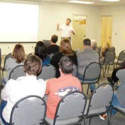 Clinton CPA Russ Meacham explains school bond financing during Sunday’s meeting. Differing views aired at school bond forum
