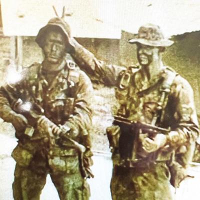 Doug Greer, right, poses with a friend during the Vietnam War. Greer gives back