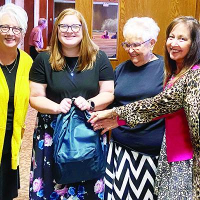 Members of the Singing Churchwomen from Clinton First Baptist Church present Southwest Elementary teacher Morgan Behrens, center, with a backpack filled with school supplies. Singing Churchwomen from left are Mary Daugherty, Janice Berrong, Lois Schimmels A kind gesture