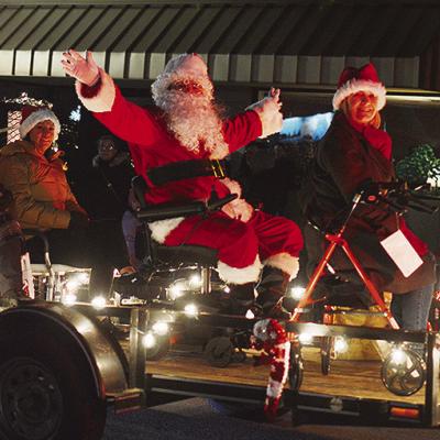 From left, Emily Weixel, Aaron Reyes, Cody Gore, and Terri Harrelson with Priority Home Medical Equipment wishes everyone a Merry Christmas from the back of their float in the Clinton Festival of Lights Christmas Parade. CDN | Micah Ashcraft