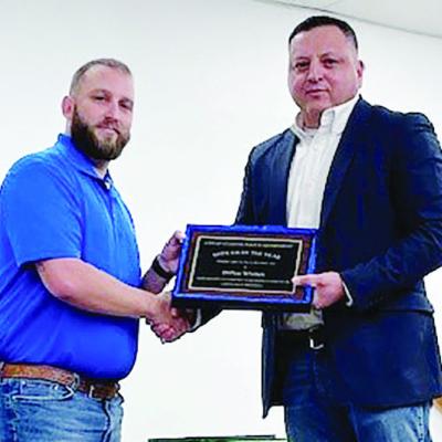 Clinton Police Officer Dillon Whitten, left, is presented with the Officer of the Year Award by Clinton Police Chief Luis De La Torre.