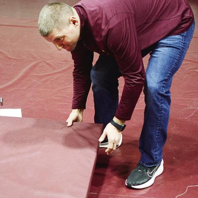Coach Rhett Blundell puts the final mat down Friday in preparation for the annual two-day Hub City Wrestling Tournament at the Tornado Dome. CDN | Sam Goodwyn