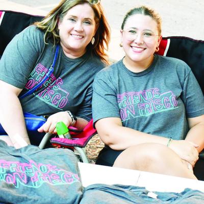 Chamber of Commerce President Julie Caldwell, left, and Financial/Marketing Director Harley Heerwald-Day sell Friends on Frisco shirts at Engleman Park. CDN | Caleb Blanchard Friends merch