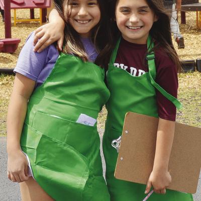 Camila Murphy, left, and Journey Patton were out at recess taking coffee orders while dressed as baristas Monday at Southwest Elementary. CDN | Christian Jacobsen