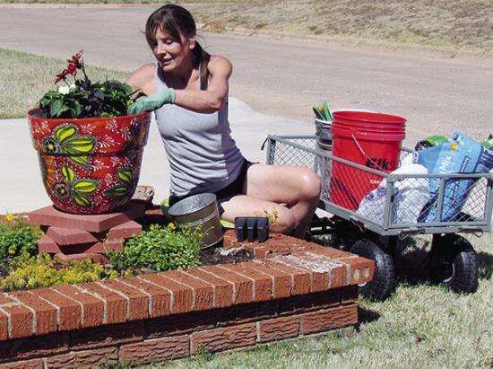 Montie Adair enjoys the recent warm weather by planting flowers at her home on Redstone Drive. CDN | Christian Jacobsen Montie Adair enjoys the recent warm weather by planting flowers at her home on Redstone Drive. CDN | Christian Jacobsen