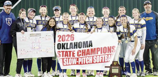 The Arapaho-Butler Lady Indians celebrate winning the 2026 Class 3A Slow-Pitch State Championship Wednesday at FireLake Ball Fields. Pictured from left, in front, are Adrian Randle, Kylin Oakes, Izzie Dewees, Reagan Schoeppach, Maddi Lockhart and Piperril